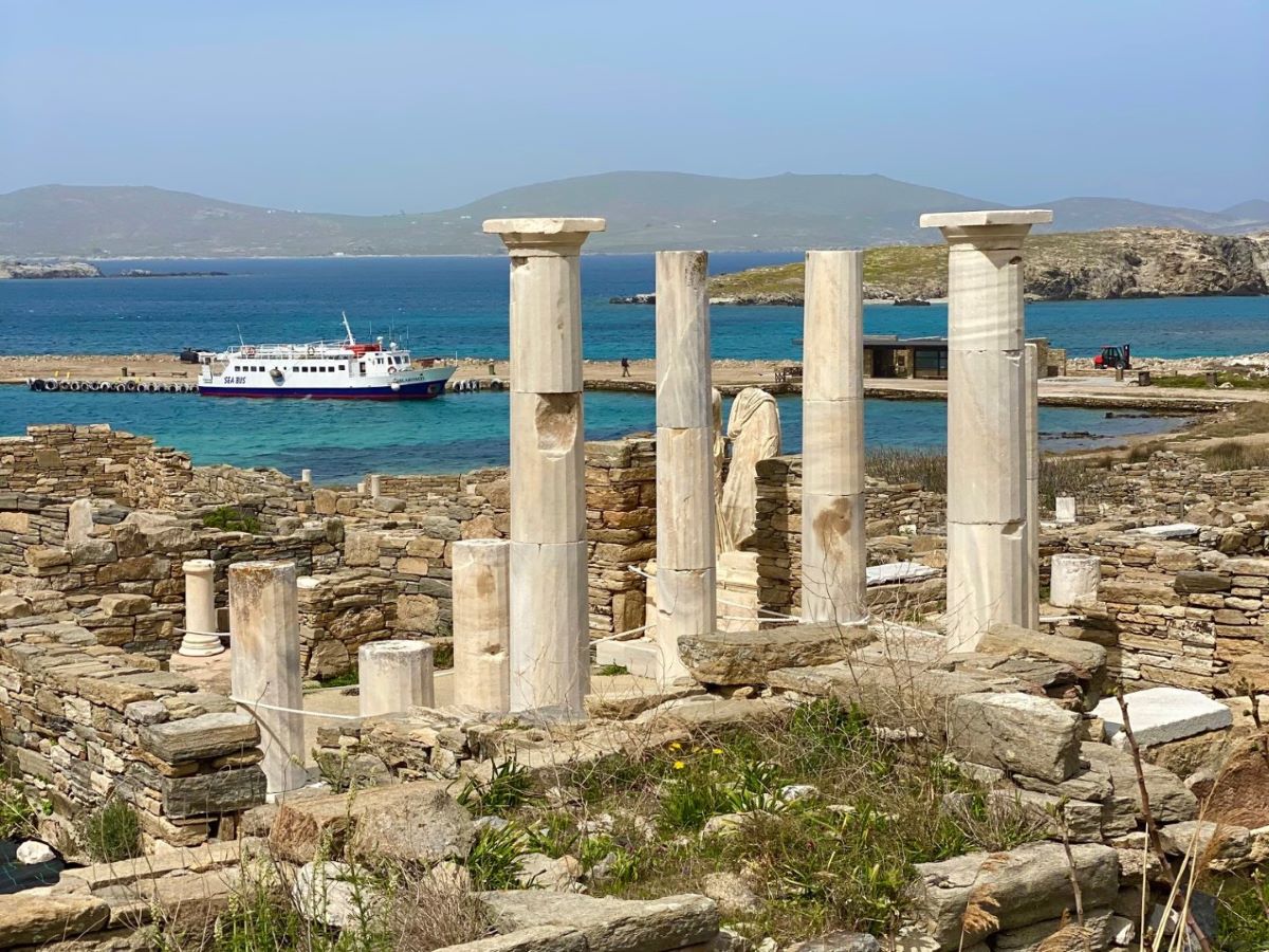 Marble columns at Delos with boat behind