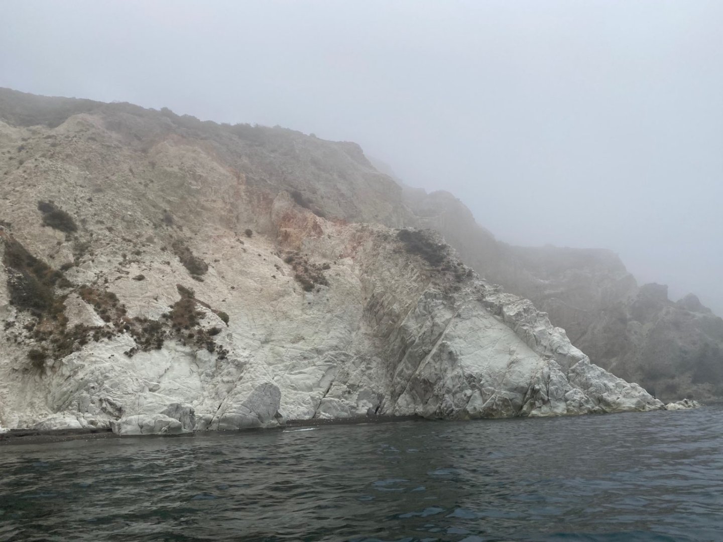 White cliffs in Santorini's morning mist